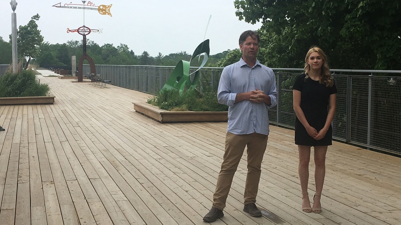 Andrew Gunn, left, and Maddie King, consultants for the Donna Bushell Estate announce donations at the St. Thomas Elevated Park on Wednesday, June 10, 2020. (Brent Lale / CTV News)