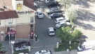 Police are shown at the scene of a shooting investigation outside a Mississauga hotel in this aerial photo. 
