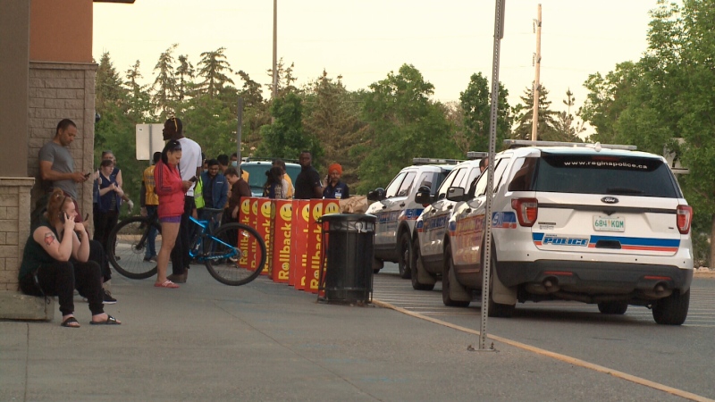 Police cars are seen outside a Walmart location off Gordon Road in Regina while customers wait outside the evening of June 12, 2020. (Gord Fiessel/CTV News Regina)