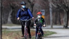 In this Wednesday, April 8, 2020, photo, bicyclists wear pandemic masks while riding in Portland, Maine. (AP Photo/Robert F. Bukaty)