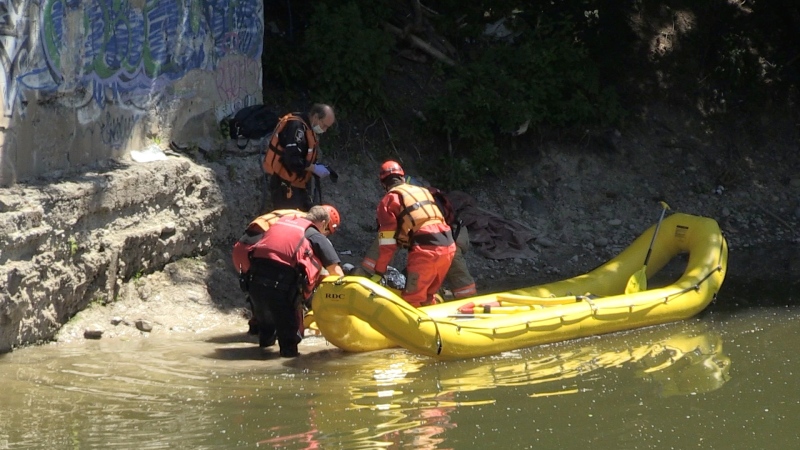 Members of the LFD Marine Unit help rescue a woman who fell down an embankment along the Thames River on Monday June 15, 2020. (Jim Knight / CTV London) 