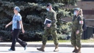 A staff member escorts members of the Canadian Armed Forces in to a long-term care home in Ontario on Saturday, April 25, 2020. THE CANADIAN PRESS/Chris Young
