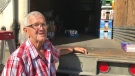 Wayne Kinney, a member of the Royal Canadian Legion Victory Branch, stands at the rear of a transport donated for a bottle drive in London, Ont. on Thursday, June 18, 2020. (Sean Irvine / CTV News)