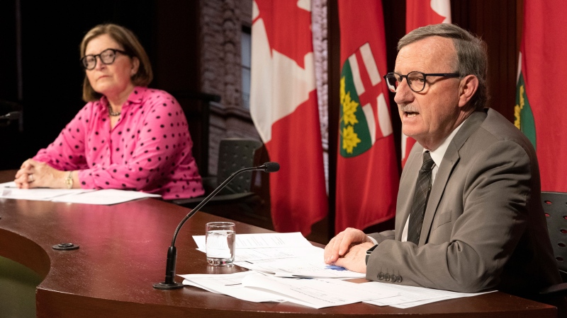 Dr. Barbara Yaffe listens as Ontario Chief Medical Officer of Health Dr. David Williams speaks at Queen's Park in Toronto on Wednesday March 25, 2020. THE CANADIAN PRESS/Frank Gunn