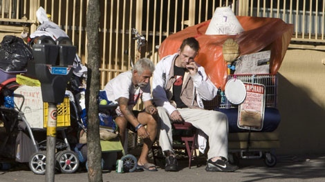 Homeless men sit along the sidewalk on East Hastings Street in downtown Vancouver, B.C., Monday, Sept. 21, 2009. (CP / Jonathan Hayward)