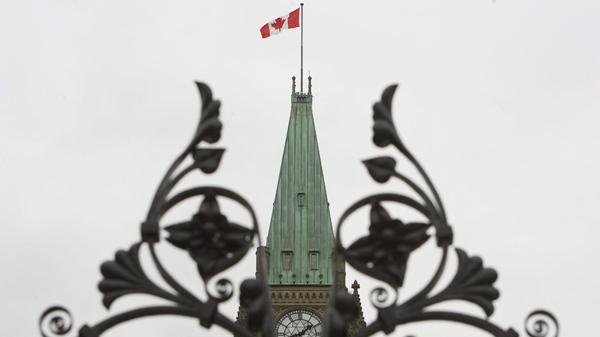 The Peace Tower on Parliament Hill is framed by the iron gates in Ottawa, Ont., on Wednesday, Sept. 16, 2009. (Sean Kilpatrick / THE CANADIAN PRESS)
