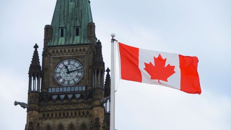 A Canadian flag flies by Parliament Hill in Ottawa on Friday, March 13, 2020. Indigenous and other racialized Canadians have been shaping the country's history and culture for centuries, but a new poll suggests most Canadians have a lot to learn about most of them. THE CANADIAN PRESS/Sean Kilpatrick