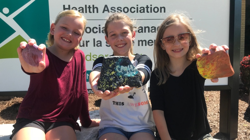 A group of Windsor kids donate proceeds from their painted rocks to the Canadian Mental Health Associationin Windsor, Ont., on June 30, 2020. (Rich Garton / CTV Windsor)