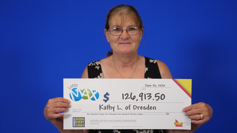 Kathy Luck shows off her winning cheque in Toronto. (Courtesy OLG)