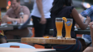 Two beers sit atop a table at an outdoor patio on Somerset St. W. in Ottawa, July 3, 2020. (Taylor Rossi / CTV News Ottawa)