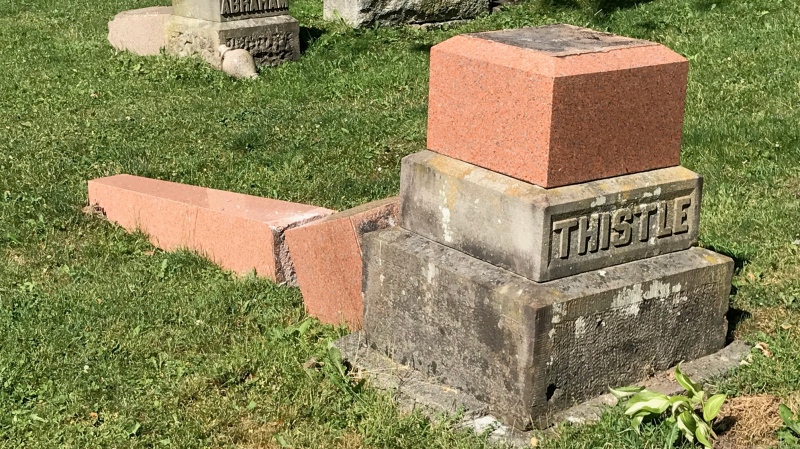 One of 75 memorial stones, many of them large and dating back decades or more, is seen toppled in Avondale Cemetery in Stratford, Ont. on Monday, July 6, 2020. (Sean Irvine / CTV News)