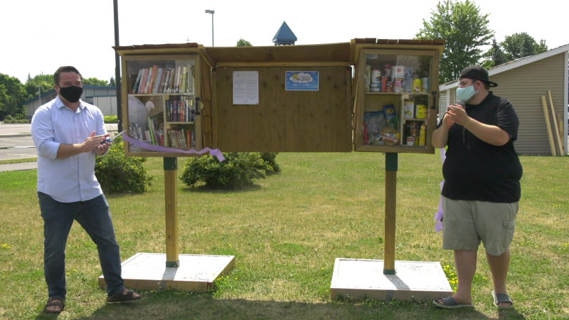 Ottawa Coun. Matthew Luloff and Redeemer Alliance Church Pastor Dylan Armstrong officially open the Orléans Community Little Library and Little Pantry on Wednesday. (Shaun Vardon/CTV News Ottawa)