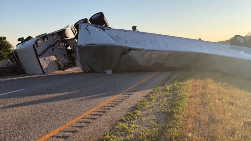 A trailer truck on its side after rolling over in the eastbound lanes of Highway 402 on Monday, July 13, 2020. (Source: OPP)