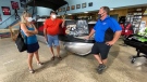Orleans Boat World & Sports owner Marc Savage helping Andre Jette and Monica Clayton shop for a boat. Ottawa, ON. July 13, 2020. (Tyler Fleming / CTV News) 