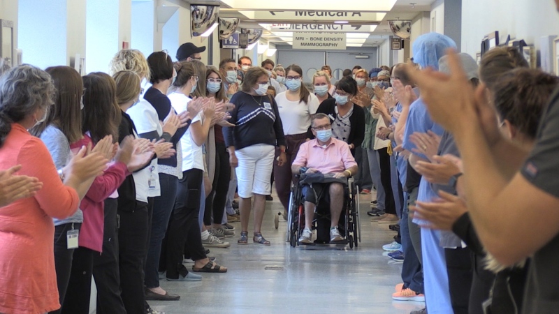 Doctors, nurses and hospital staff line the hallway of the Valley Regional Hospital in Kentville, N.S., on July 14, 2020, to give Al Poirier a grand send-off. (CTV ATLANTIC / NATASHA PACE)