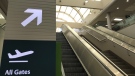 A sign at the Regina International Airport directs visitors up the escalators to the gates. (Stefanie Davis/CTV News)