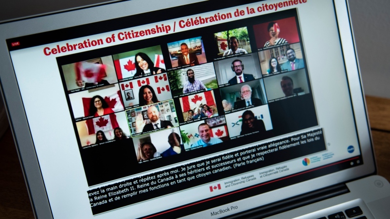 Participants celebrate becoming Canadian citizens after swearing the oath of citizenship during a virtual citizenship ceremony held over livestream due to the COVID-19 pandemic, on Canada Day, Wednesday, July 1, 2020, seen on a computer in Ottawa. (THE CANADIAN PRESS / Justin Tang)