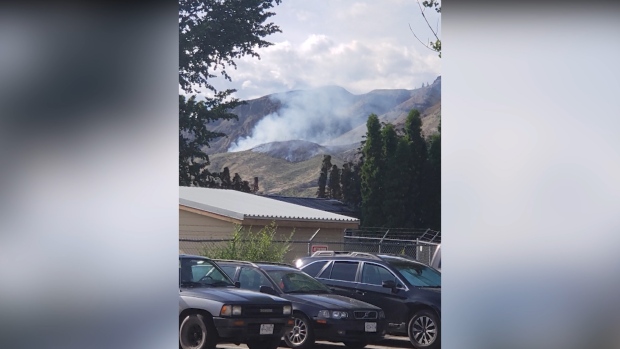 A small wildfire is seen near a Kamloops composting facility. (BC Wildfire Service/Twitter)