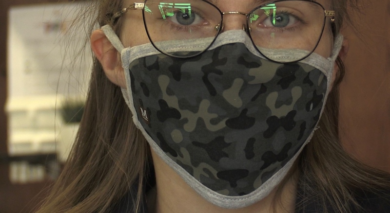 Olivia Howard, an employee at McCarthy Uniforms, shows off a mask in London, Ont. on Wednesday, July 15, 2020. (Jordyn Read / CTV News)