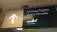 An arriving flights sign is pictured at the Regina International Airport. (Cole Davenport/CTV News)