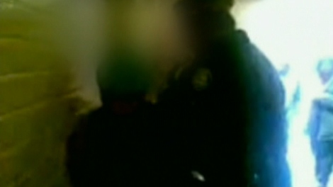 A police officer is seen arresting a student at Toronto's Northern Secondary School in this image taken from video.