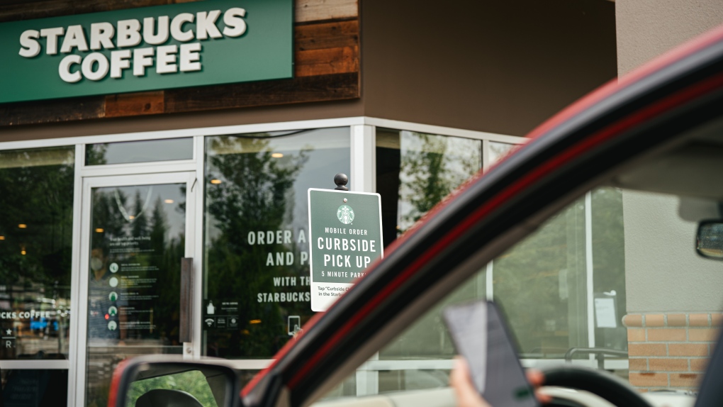 A customer drives up to a Starbucks. 