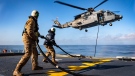 Crewmembers aboard HMCS Halifax conduct inflight refueling with a CH-148 Cyclone helicopter, call sign Kingfisher, during Operation Reassurance in the Mediterranean Sea on Jan. 6, 2020. (Corporal Braden Trudeau, Trinity / Formation Imaging Services)