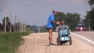 Huron County runner Peter Meades picks up trash and collects it in a child stroller as part of Project Run on July 23, 2020. (Scott Miller/CTV London)