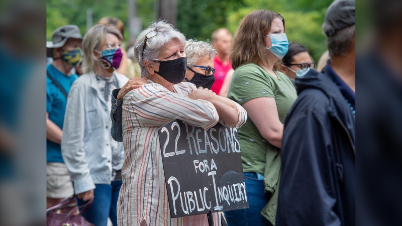 Protesters gather in Halifax's Victoria Park to demand a public inquiry into the deadly mass shootings that claimed 22 lives in Nova Scotia last April, on Monday, July 27, 2020. The federal and provincial governments have announced a review of the massacre that will not be able to compel witnesses or testimony, no power to subpoena evidence and won't be able to make binding recommendations to the government. (THE CANADIAN PRESS/Andrew Vaughan)