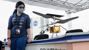 Vaneeza Rupani, of Northport, Alabama stands next to model of the helicopter she named in a contest during news conference at the Kennedy Space Center Tuesday, July 28, 2020, in Cape Canaveral, Fla. Rupani, came up with the name Ingenuity for the helicopter that will go to Mars along with the Mars 2020 rover. (AP / John Raoux)