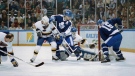 In this Friday, April 7, 1990 file photo, St. Louis Blues goalie Curtis Joseph makes a leg save against the Toronto Maple Leafs' Ed Olczyk (16) while teammate Wendel Clark (17) looks on during first period action of their NHL playoff game in St. Louis. The NHL hasn't had best-of-five playoff series since 1986. (AP Photo/Andy Hoekstra, File)