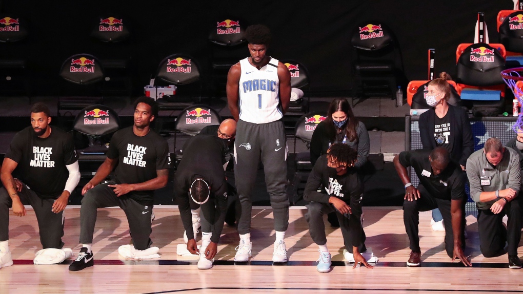 Spurs coach Gregg Popovich, Magic's Jonathan Isaac stand for anthem