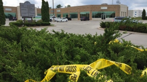 Police tape remains at the scene where a man was allegedly struck by a vehicle in a hit and run on Sun., Aug. 9, 2020, at 61 King Street in the parking lot in Barrie. (Steve Mansbridge/CTV News)