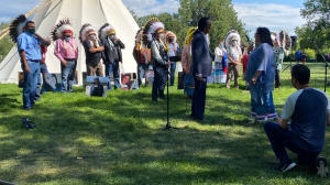 Chiefs from the Federation of Sovereign Indigenous Nations meet with Tristen Durocher at the Walking with our Angels site on the legislature grounds. (CTV Regina)