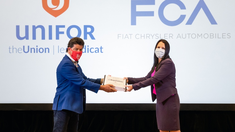 Unifor president Jerry Dias and FCA Canada head of human resources Jacqueline Olivia mark official start of bargaining with document exchange in Toronto, Ont. on Wednesday, Aug. 12 2020. (courtesy FCA Canada)