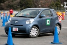 A visitor takes a turn during a test drive of a Toyota Motor Co.'s compact car iQ during a Toyota-sponsored event to promote its cars in Mimasaka in Okayama, southwestern Japan, Saturday, May 28, 2009. Toyota's new little car doesn't boast any glamorous hybrid or plug-in technology. But the iQ is a star in its own right for more mundane features that are just as critical in car-making _ safety, fuel-efficiency, handling and sheer tiny size. 