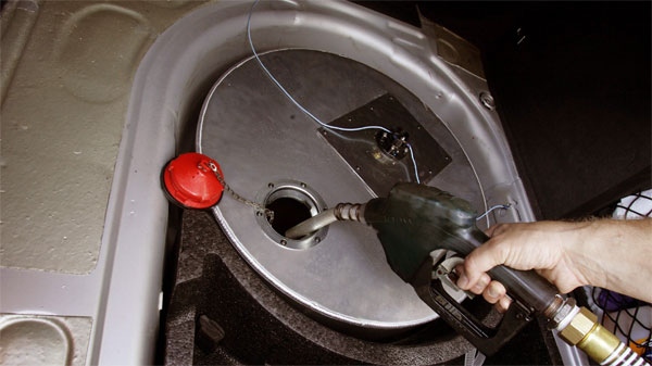 In this file photo, a man put vegetable oil into a spare tank in his car. 