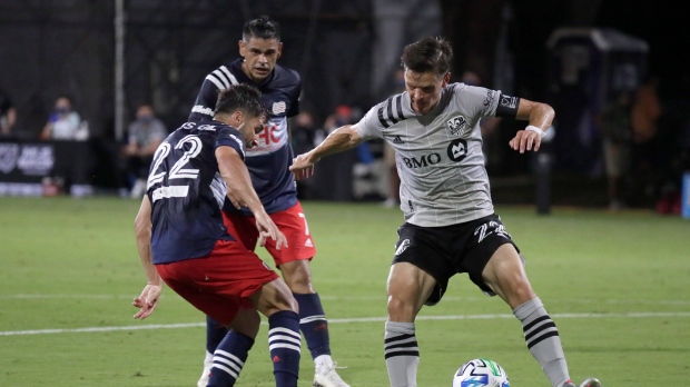 Montreal Impact defender Jukka Raitala, right, battles for the ball with New England Revolution midfielder Carles Gil, left, and midfielder Brandon Bye, center, during the first half of an MLS soccer match, Thursday, July 9, 2020, in Kissimmee, Fla. (THE CANADIAN PRESS/AP/John Raoux)