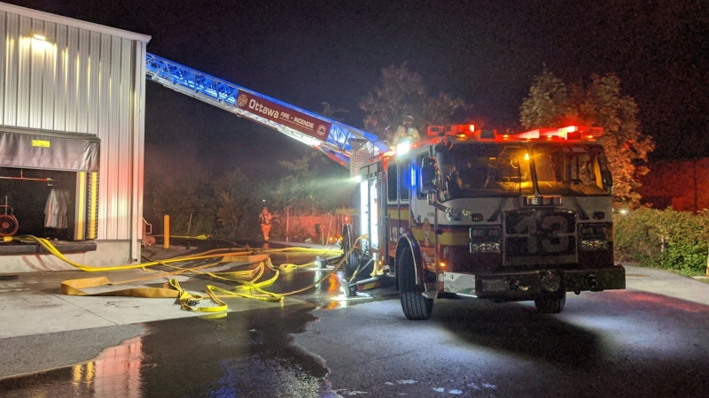 Ottawa firefighters respond to a fire at Canadian Linen and Uniform Services on Russell Road, late Aug. 15, 2020. (Photo courtesy of Scott Stilborn @OFSFirePhoto / Twitter)