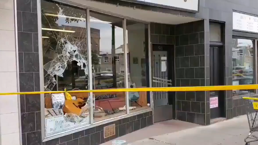 Caution tape and a broken window at a store