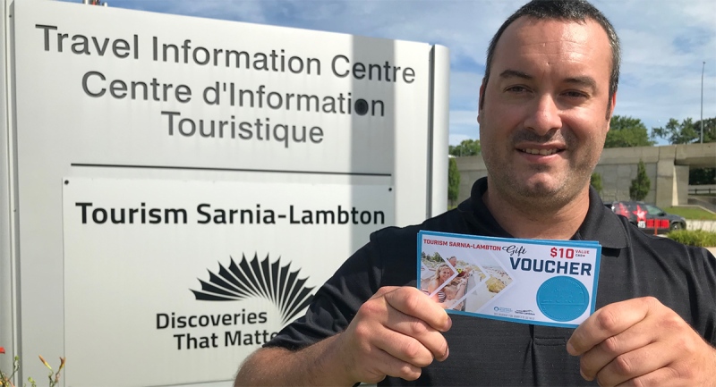 Mark Perrin, executive director of Tourism Sarnia-Lambton, holds vouchers created to entice more people to stay, eat and shop in the region. The voucher debuted Monday, Aug. 17, 2020, with $300,000 worth to be pumped into the local economy. (Sean Irvine / CTV News)