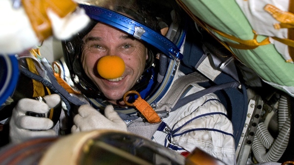 Canadian space tourist Guy Laliberte smiles while sitting inside the Soyuz spacecraft, shortly after landing near Arkalyk, Kazakhstan, on Sunday, Oct. 11, 2009. (AP / Sergei Remezov, Pool)