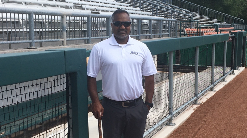 Roop Chanderdat, London Majors co-owner and manager, shows off the new railings in front of the dugouts at Labatt Park in London, Ont. on Tuesday, Aug. 18, 2020. (Brent Lale / CTV News)