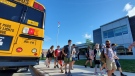 Students at Jonathan Pitre French Catholic Elementary School get off their school bus Aug. 19, 2020, for their first day of school. (Jeff McDonald / CTV News Ottawa)