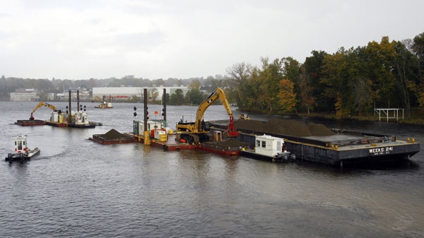 Tugs and barges take part in a dredging project on section of the Hudson River in Fort Edward, N.Y., on Wednesday, Oct. 7, 2009. (AP Photo / Mike Groll)