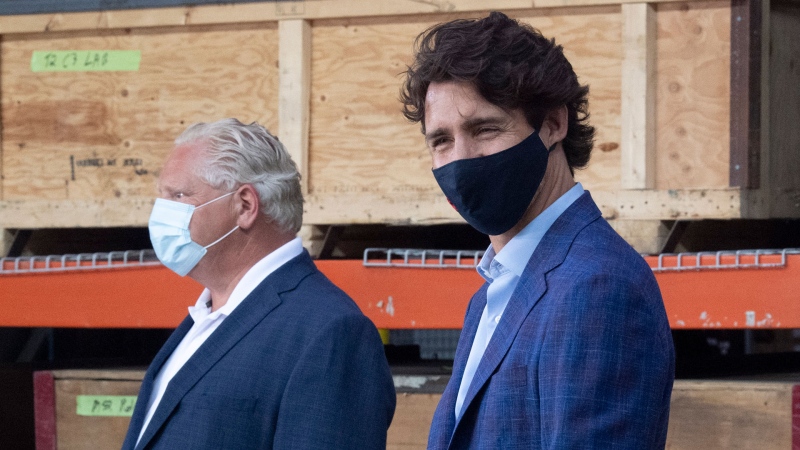 Prime Minister Justin Trudeau stands with Ontario Premier Doug Ford during an announcement on N95 masks at a facility in Brockville, Ont., Friday, Aug. 21, 2020. THE CANADIAN PRESS/Adrian Wyld
