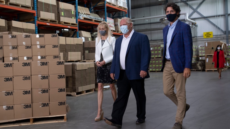 3M Canada President Penny Wise, Ontario Premier Doug Ford and Prime Minister Justin Trudeau make their way to an announcement at a facility in Brockville, Ont., Friday, Aug. 21, 2020. THE CANADIAN PRESS/Adrian Wyld