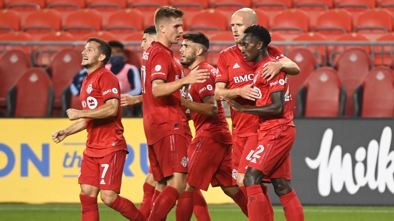 Toronto FC midfielder Richie Laryea (22) celebrates his goal with Toronto FC midfielder Michael Bradley (4) while Playing against the Vancouver Whitecaps during first half MLS Canadian Championship soccer action in Toronto on Friday, August 21, 2020. THE CANADIAN PRESS/Nathan Denette