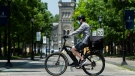 A person bicycles past the University of Toronto campus during the COVID-19 pandemic in Toronto on Wednesday, June 10, 2020. The Ontario government announces the framework for reopening of colleges and universities as early as of July. THE CANADIAN PRESS/Nathan Denette