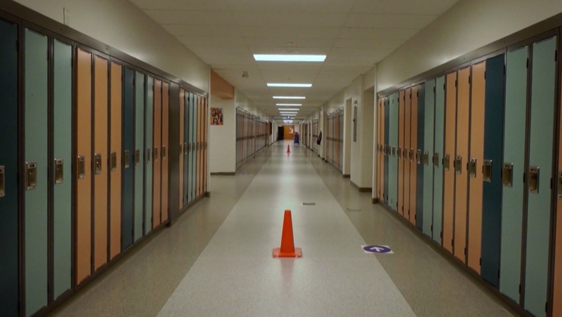 Pylons divide a school hallway in Calgary as directional arrows aim to direct foot traffic as school resumes during the COVID-19 pandemic. (file)